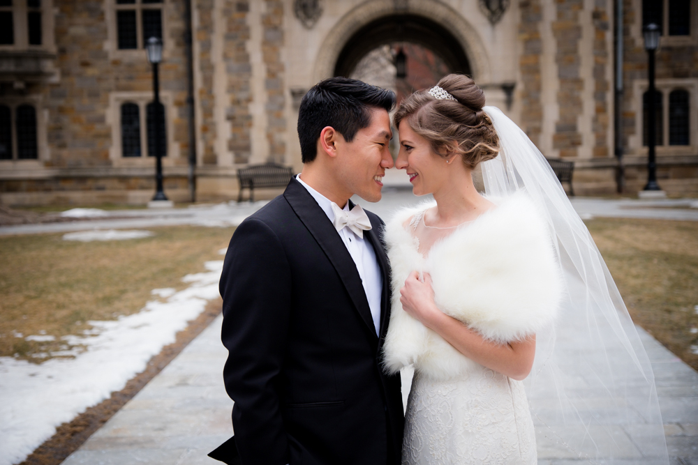 Bride and groom forehead to forehead in Ann Arbor Law Quad